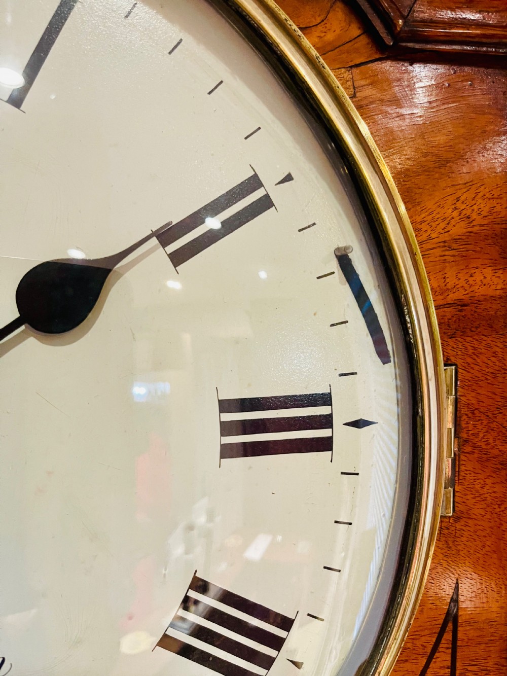 A Georgian flame mahogany longcase clock featuring three brass urn finials, a circular dial signed Davie High Holborn London, and a long arched trunk door. View XVII