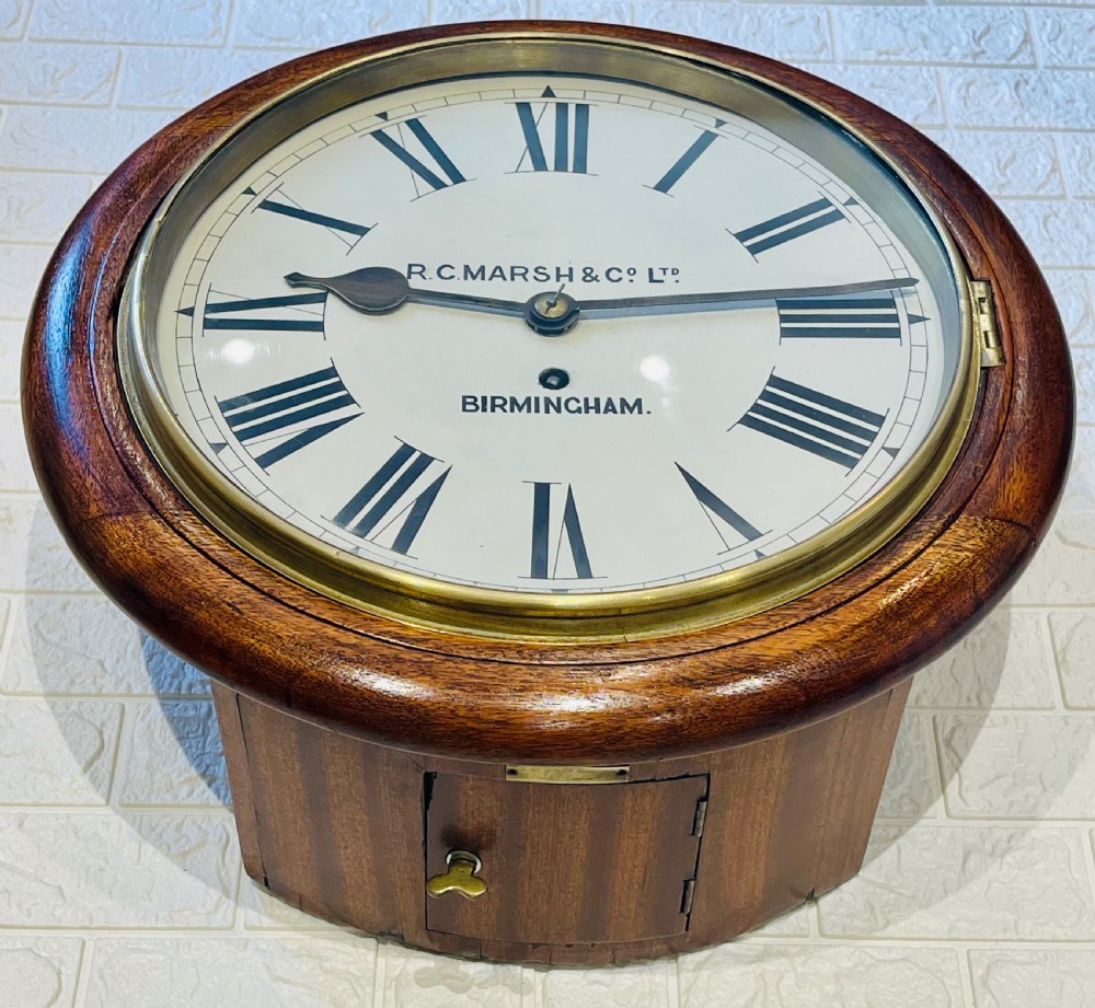 A circular Victorian oak fusee wall clock featuring a white dial with Roman numerals, black hands, and a brass bezel. View II