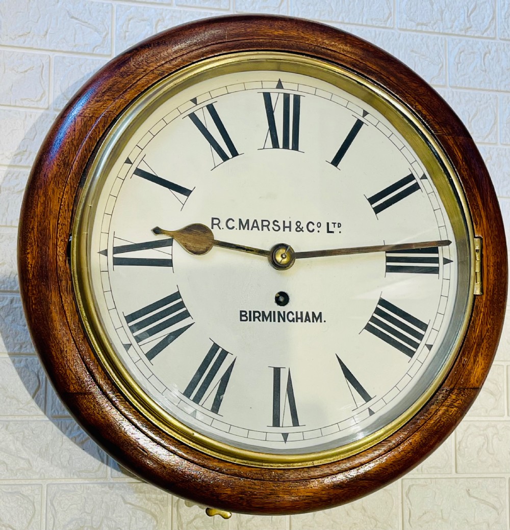 A circular Victorian oak fusee wall clock featuring a white dial with Roman numerals, black hands, and a brass bezel. View III