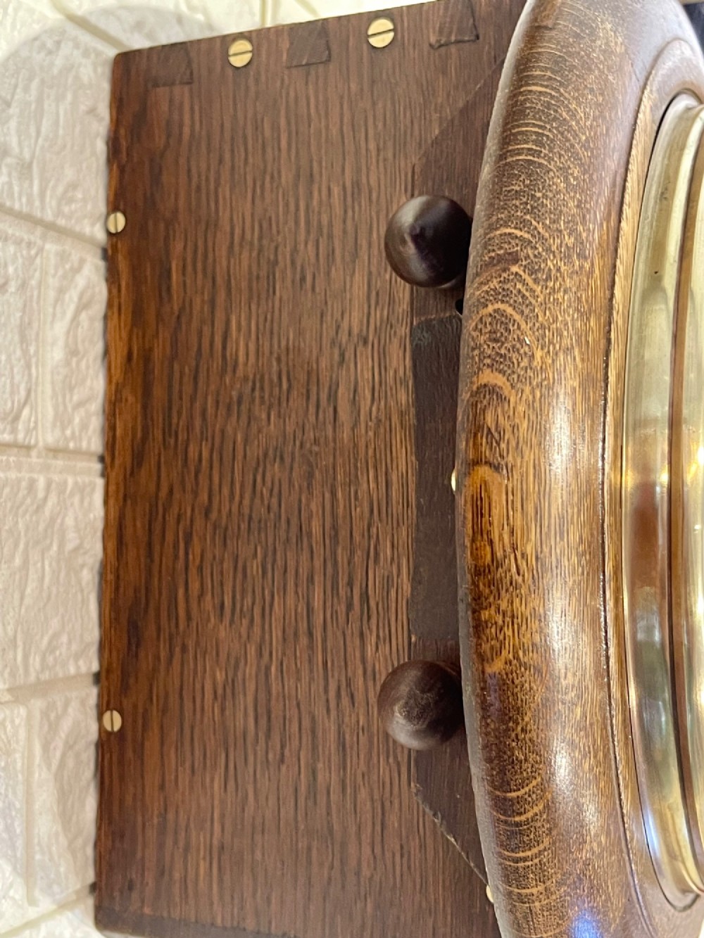 A circular oak wall clock featuring a brass bezel, Roman numerals, and British Rail markings printed on the dial. View VIII