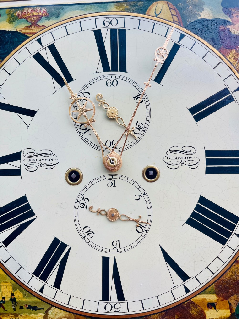 A Georgian flame mahogany longcase clock featuring a swan-neck pediment and a hand-painted arch dial. View VI