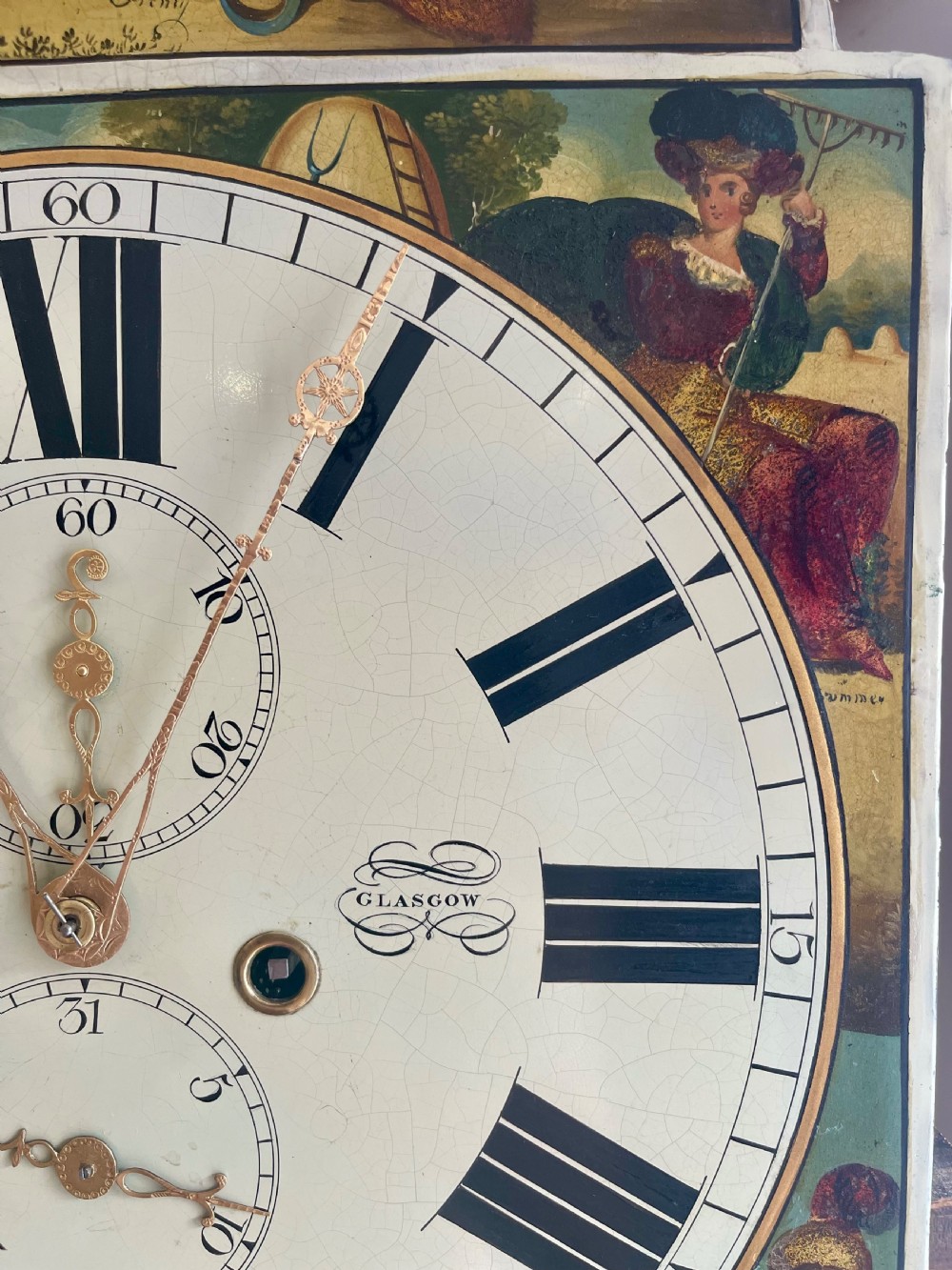 A Georgian flame mahogany longcase clock featuring a swan-neck pediment and a hand-painted arch dial. View XXI