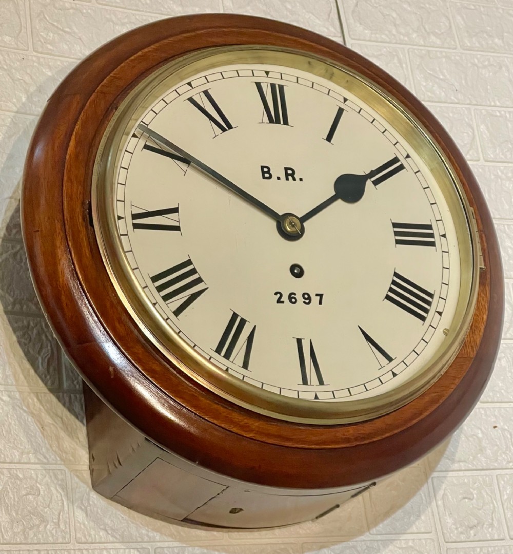A circular antique mahogany fusee wall clock featuring a cream dial marked B.R., Roman numerals, black hands, and a brass bezel. View II