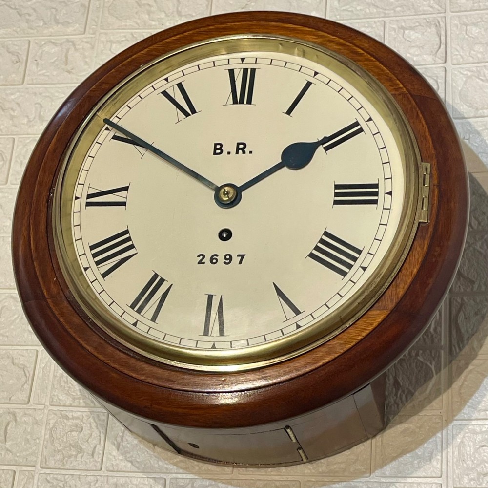 A circular antique mahogany fusee wall clock featuring a cream dial marked B.R., Roman numerals, black hands, and a brass bezel. View V