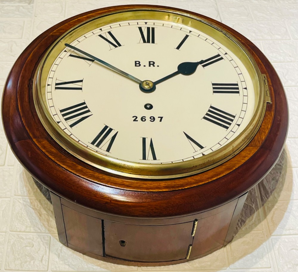 A circular antique mahogany fusee wall clock featuring a cream dial marked B.R., Roman numerals, black hands, and a brass bezel. View VI