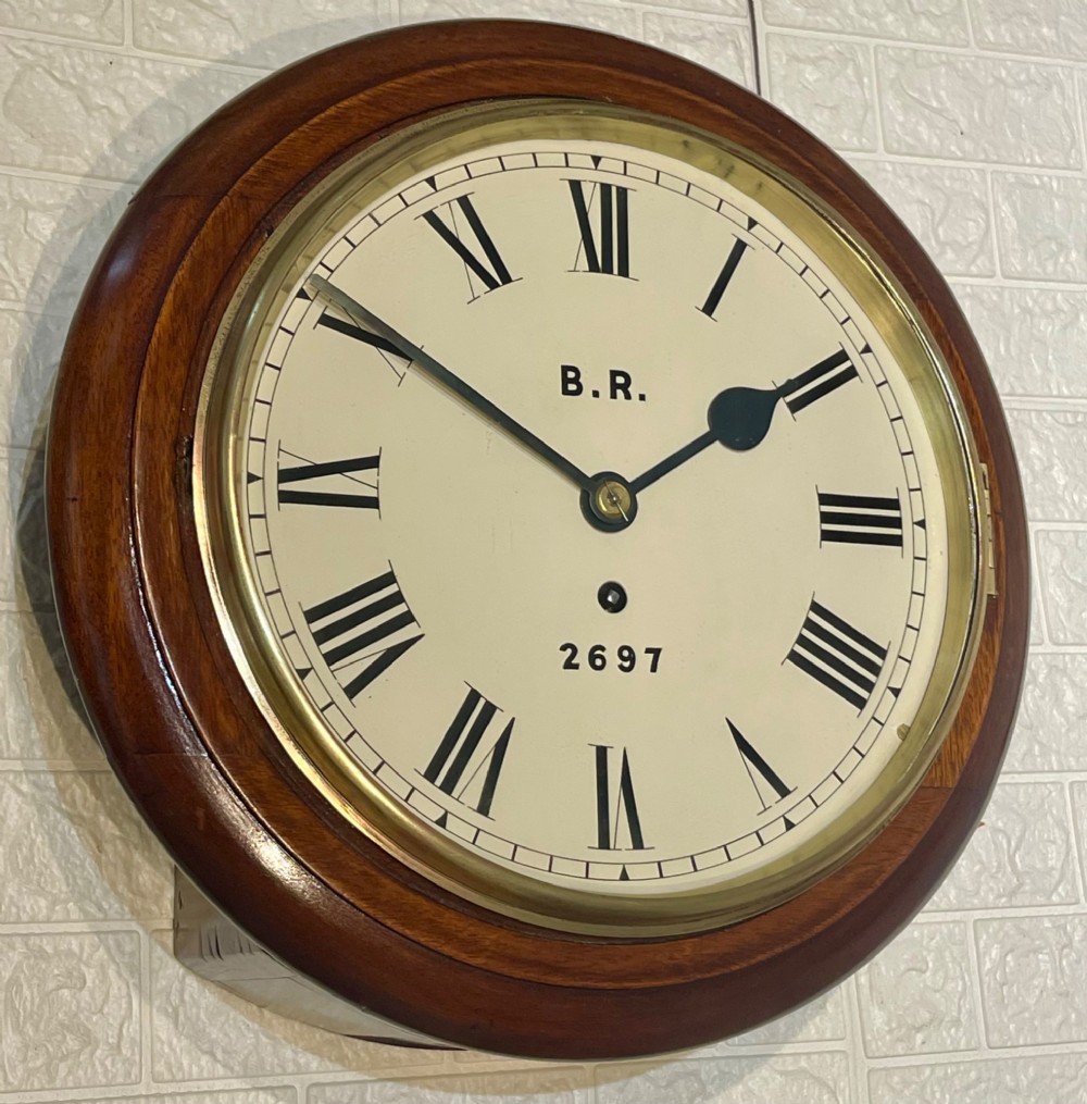 A circular antique mahogany fusee wall clock featuring a cream dial marked B.R., Roman numerals, black hands, and a brass bezel. View VII