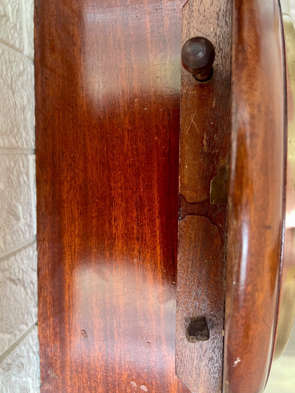 A circular antique mahogany fusee wall clock featuring a cream dial marked B.R., Roman numerals, black hands, and a brass bezel. View VIII