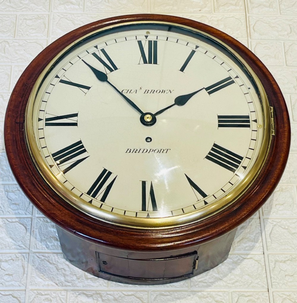 A circular Georgian fusee wall clock with a dark mahogany frame, a cream painted dial with Roman numerals, and a polished brass bezel. View III