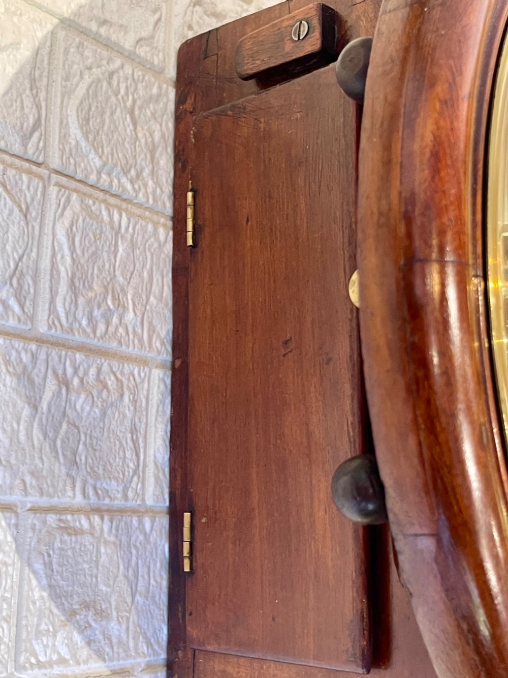 A circular antique mahogany railway dial wall clock with a painted off-white face, Roman numerals, brass bezel, and British Railways marking. View X