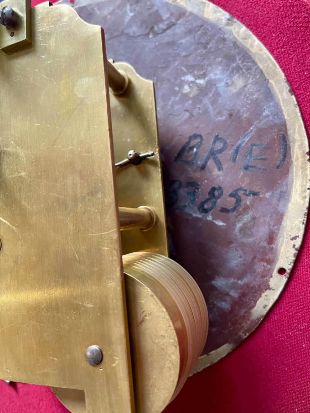 A circular antique mahogany railway dial wall clock with a painted off-white face, Roman numerals, brass bezel, and British Railways marking. View XIII