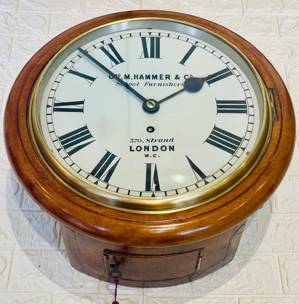 A circular Victorian mahogany wall clock featuring a white dial with black Roman numerals, a polished brass bezel, and London maker inscription. View III