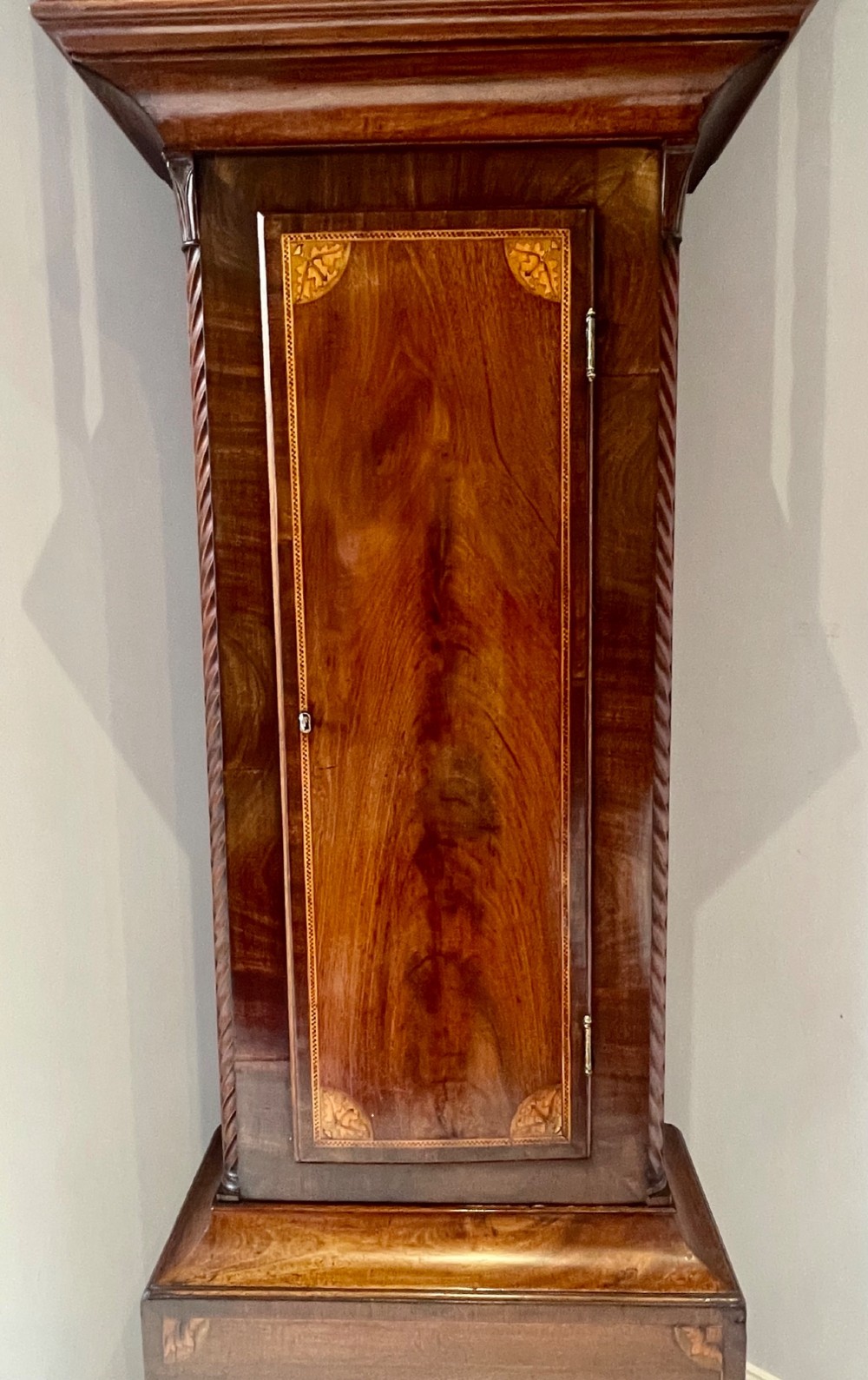 An antique Scottish Georgian mahogany longcase clock featuring a hand-painted dial, spiral turned columns, and marquetry inlay. View VI