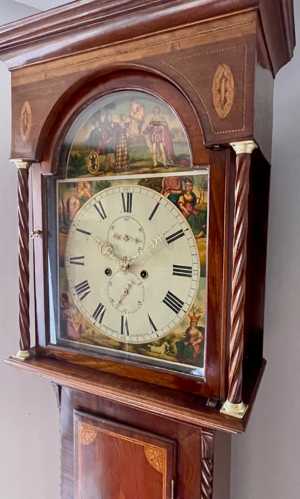 An antique Scottish Georgian mahogany longcase clock featuring a hand-painted dial, spiral turned columns, and marquetry inlay. View X