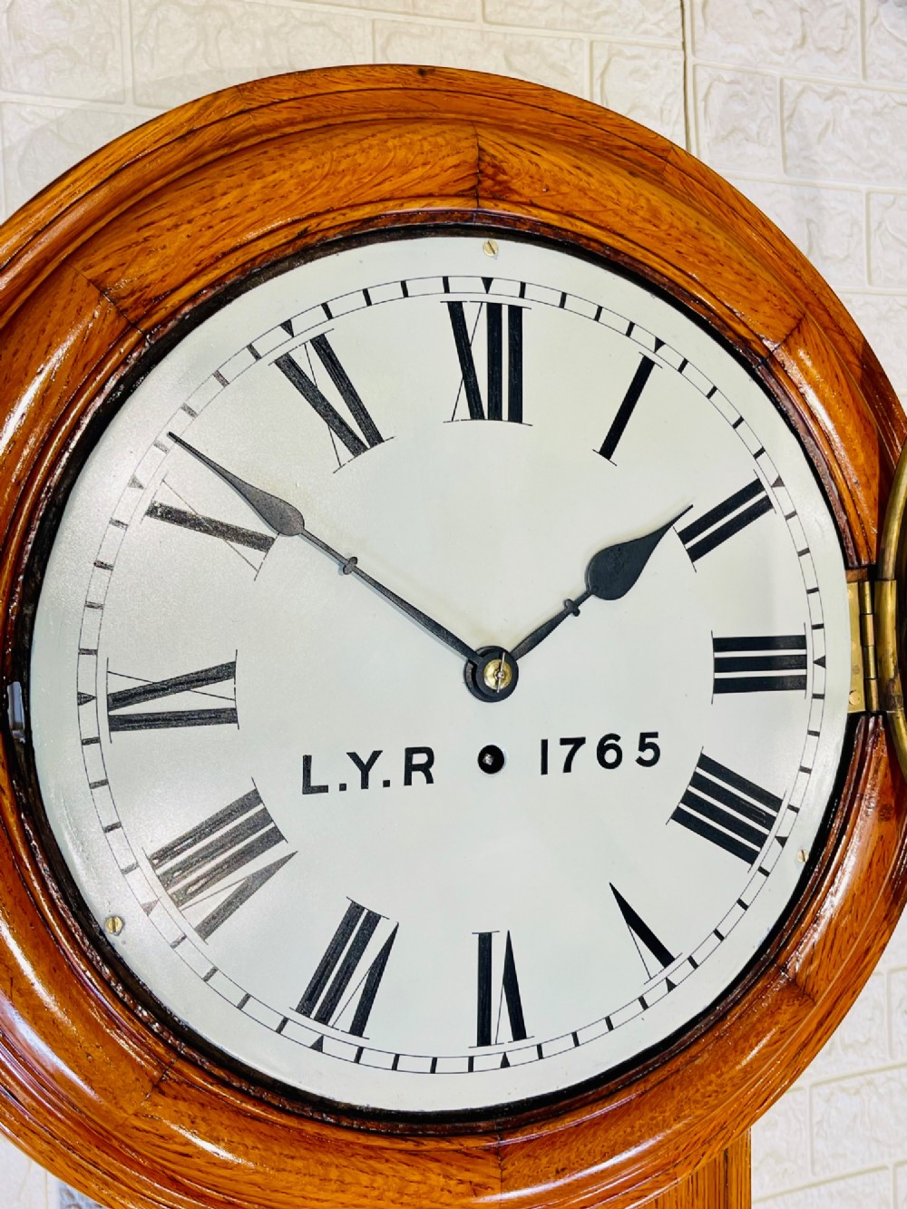 An antique oak drop dial wall clock featuring a white face with Roman numerals, marked L.Y.R 1765 with a brass bezel. View XIII