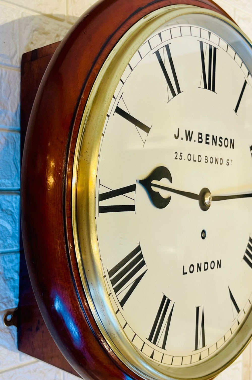 A circular mahogany fusee wall clock featuring a white dial face with black Roman numerals, brass bezel, and J. W. Benson London markings. View II