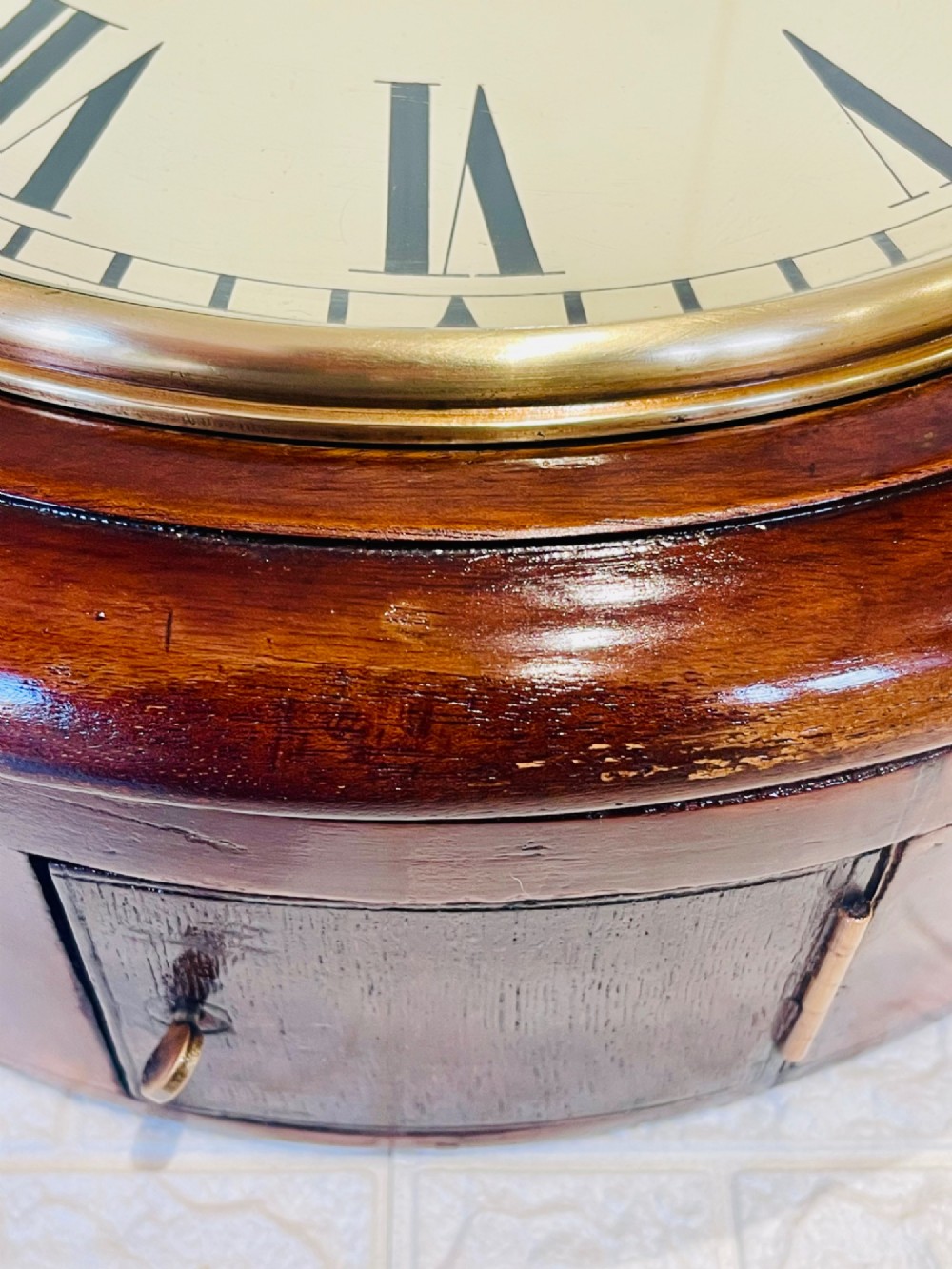 A circular Victorian railway dial clock with a dark mahogany frame, brass bezel, and off-white dial featuring black Roman numerals. View III