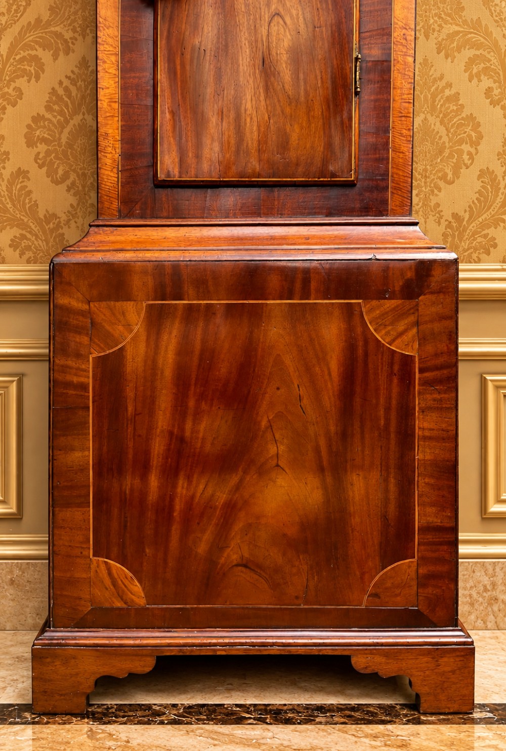 A tall Regency mahogany longcase clock featuring a swan-neck hood pediment, brass finial, fluted columns, and a hand-painted dial with figurative scenes. View IV