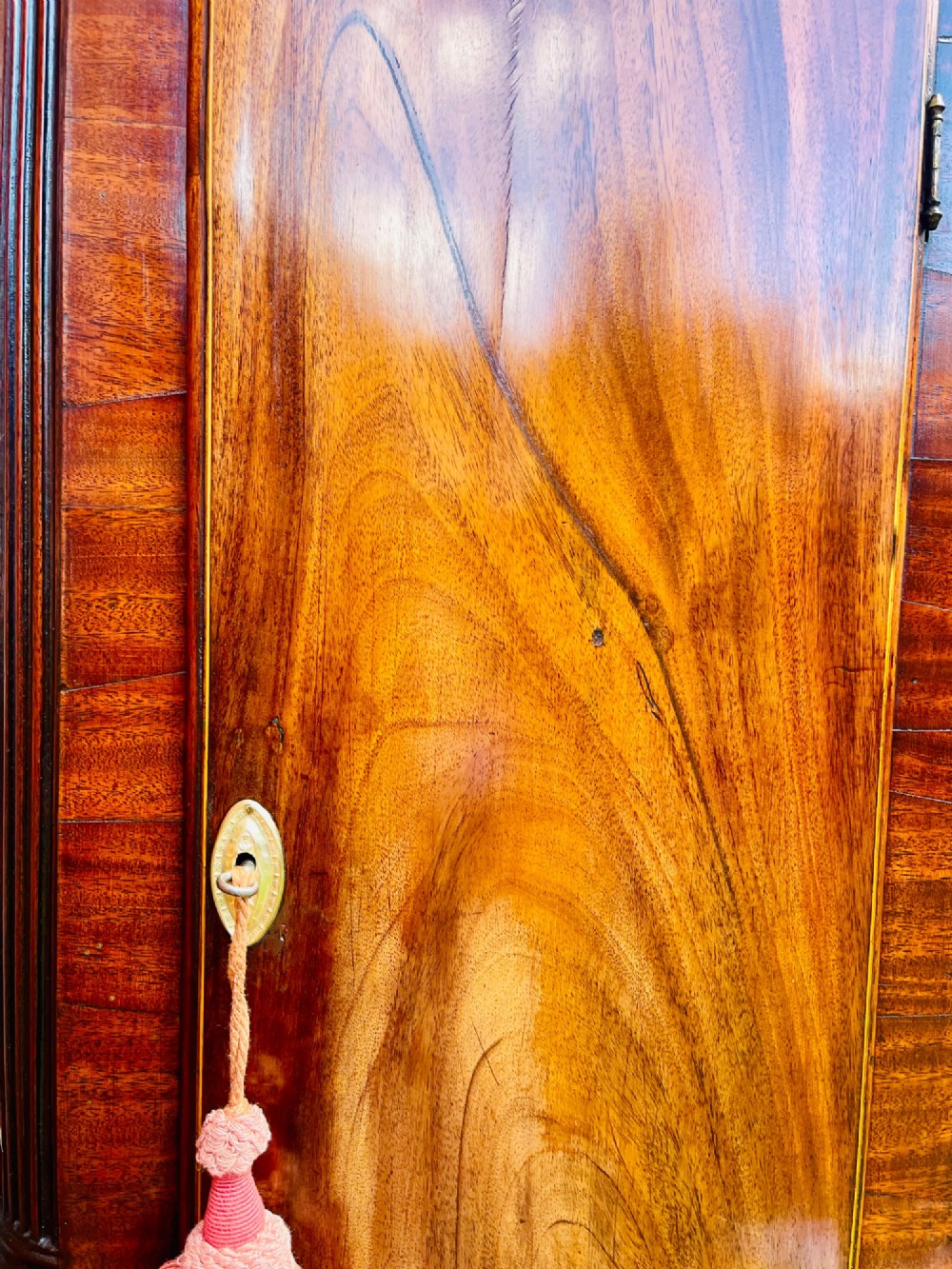 A tall Regency mahogany longcase clock featuring a swan-neck hood pediment, brass finial, fluted columns, and a hand-painted dial with figurative scenes. View XIII