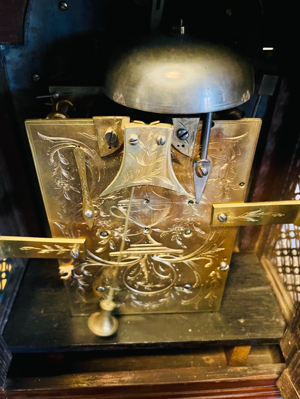 A George III mahogany bracket clock featuring an arched case with a brass top handle, gilt spandrels, and a silvered dial. View VIII