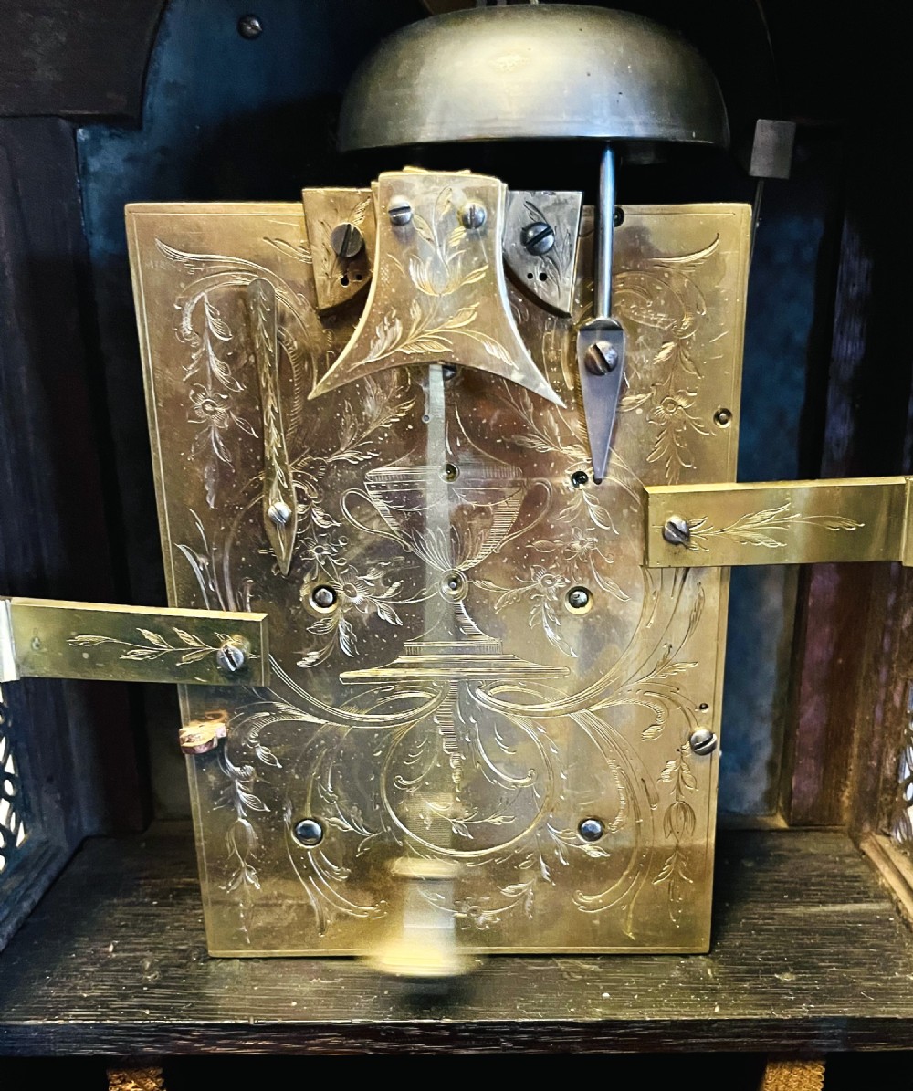 A George III mahogany bracket clock featuring an arched case with a brass top handle, gilt spandrels, and a silvered dial. View IX