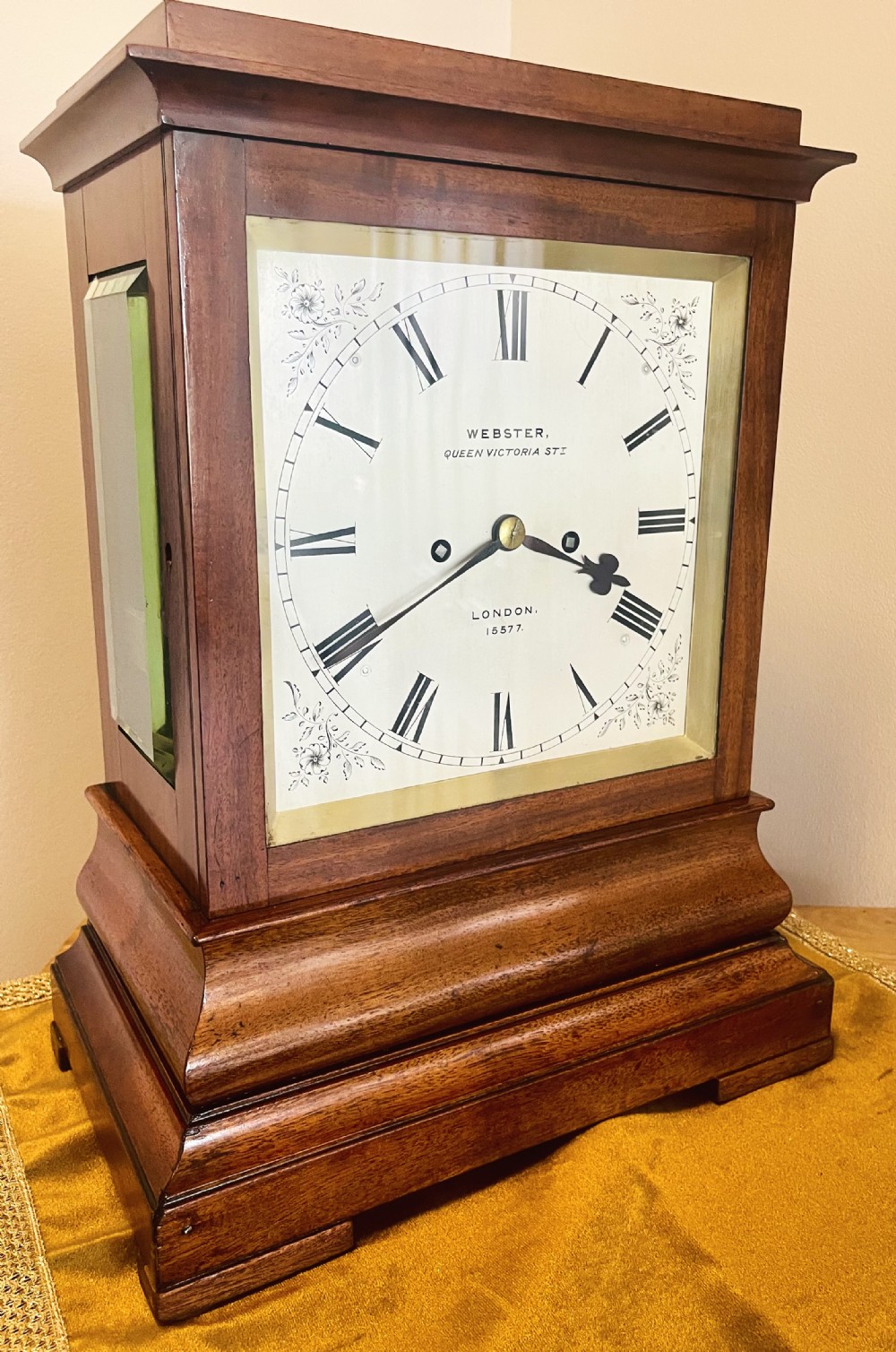A Victorian mahogany four-glass bracket clock featuring a white dial with Roman numerals and a moulded stepped base.