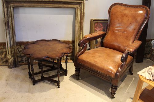 fig 2. A late Victorian walnut occasional table featuring a scalloped multi-lobed top with a raised rim, supported by turned legs and cross stretchers.