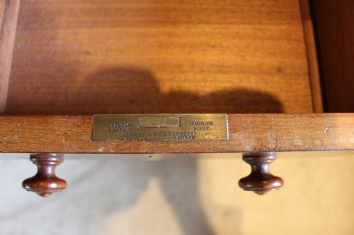 fig 7. An early Victorian mahogany partners desk featuring a black leather writing top, twin pedestals with multiple drawers, and turned wooden handles.