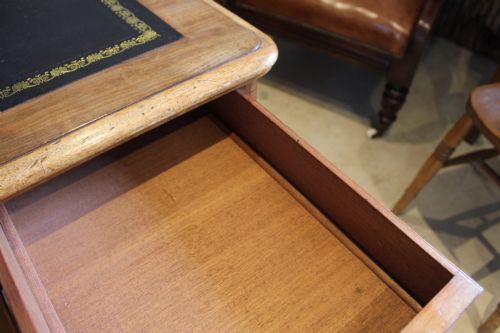 fig 9. An early Victorian mahogany partners desk featuring a black leather writing top, twin pedestals with multiple drawers, and turned wooden handles.