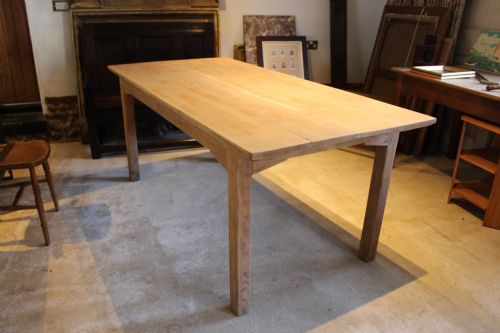 fig 2. An Edwardian light oak farmhouse refectory dining table featuring straight square legs and a spacious rectangular plank top.