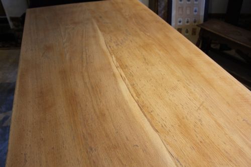 fig 3. An Edwardian light oak farmhouse refectory dining table featuring straight square legs and a spacious rectangular plank top.