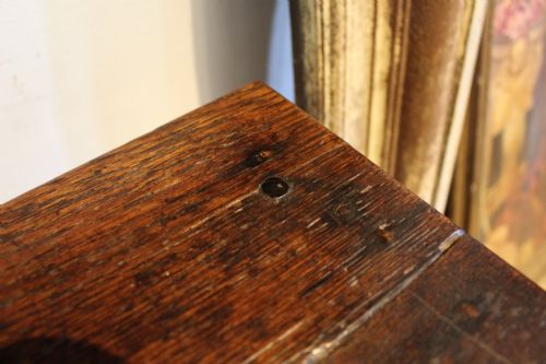 fig 5. A dark oak George I side table featuring a rectangular plank top, pegged mortise and tenon joinery, and square legs joined by lower stretchers.