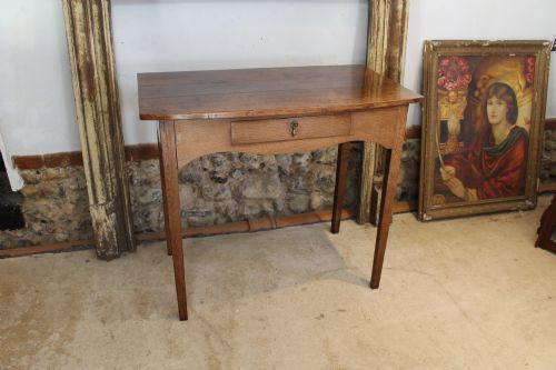 fig 2. A George III country oak side table featuring a single frieze drawer with a brass drop handle, a shaped apron, and four straight legs.