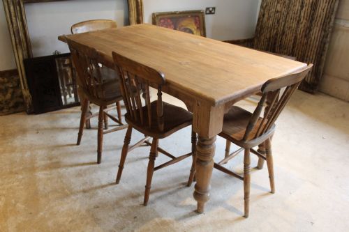 fig 1. An Edwardian rectangular pitch pine dining table with a thick plank top and four stout turned legs.