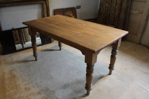 fig 2. An Edwardian rectangular pitch pine dining table with a thick plank top and four stout turned legs.