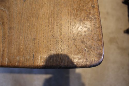 fig 5. An antique French oak refectory dining table featuring a solid two-plank top, a side frieze drawer, and square tapered legs.