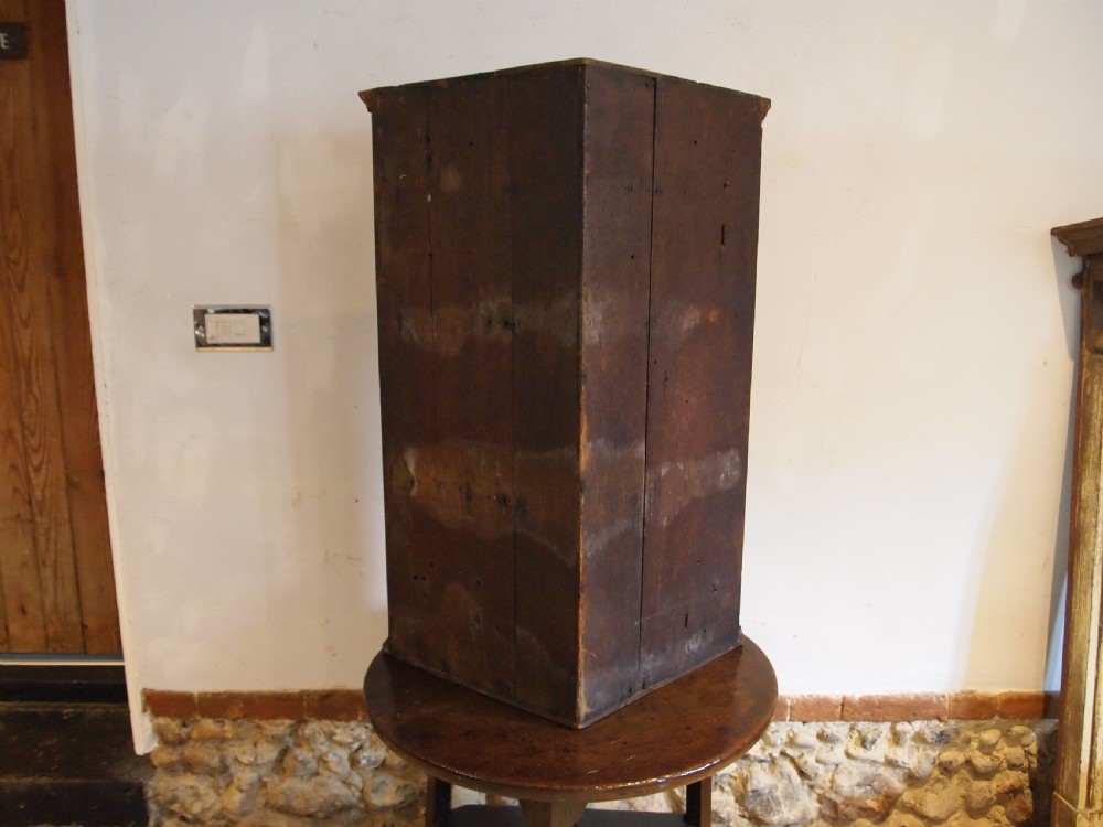 A dark walnut bowfront corner cabinet featuring two doors detailed with geometric mother of pearl inlay and brass hinges. View X