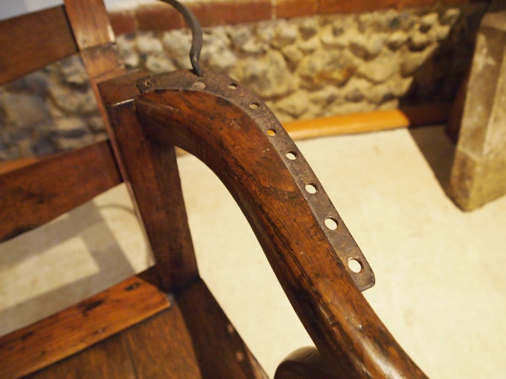 A late 18th-century George III oak and elm reclining ladderback armchair with curved arms and iron side stays. View VI