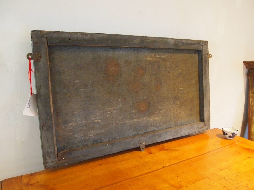 A rectangular hand-painted antique metal shop sign featuring black lettering outlined in red reading Boot W Massingham Repairs against a grey background within a dark metal frame. View VII