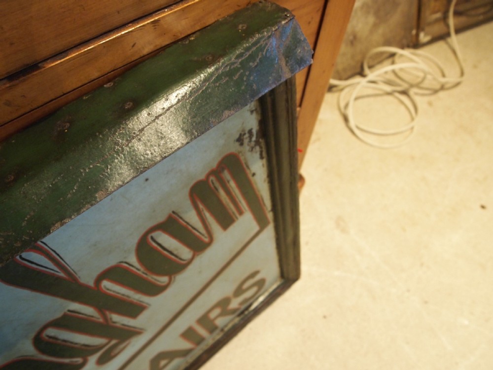A rectangular hand-painted antique metal shop sign featuring black lettering outlined in red reading Boot W Massingham Repairs against a grey background within a dark metal frame. View XI