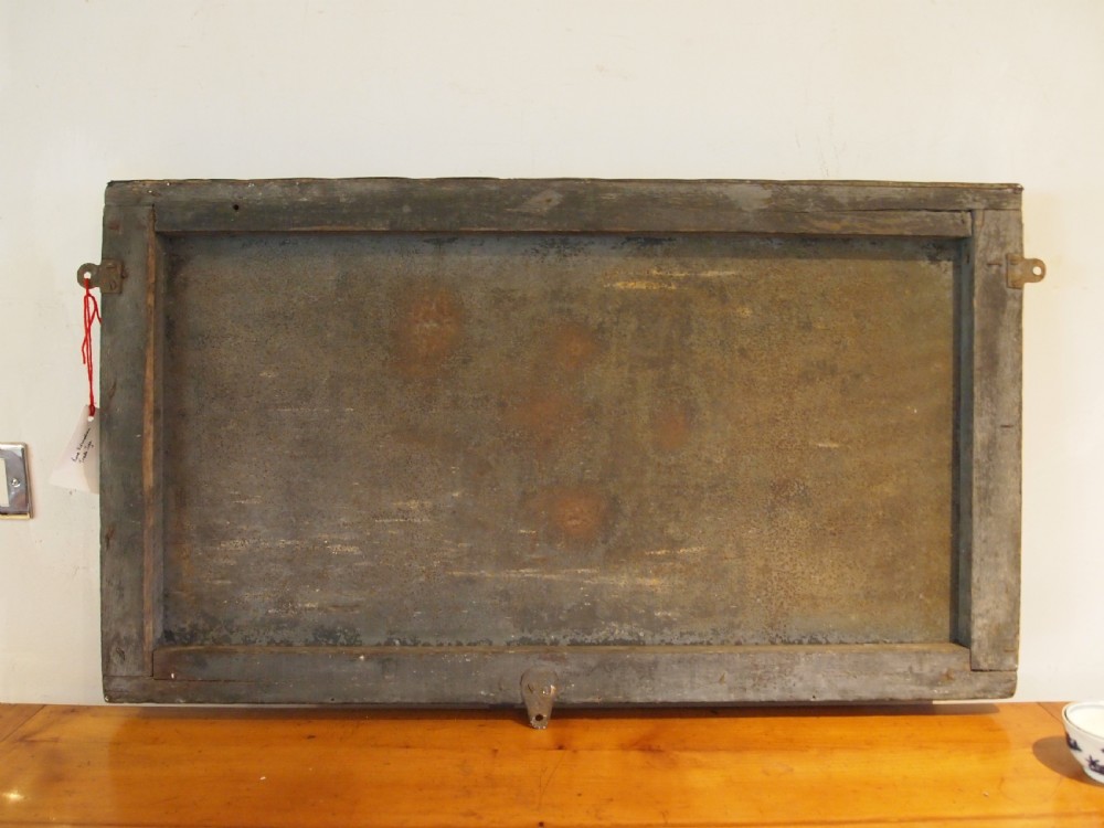 A rectangular hand-painted antique metal shop sign featuring black lettering outlined in red reading Boot W Massingham Repairs against a grey background within a dark metal frame. View XII
