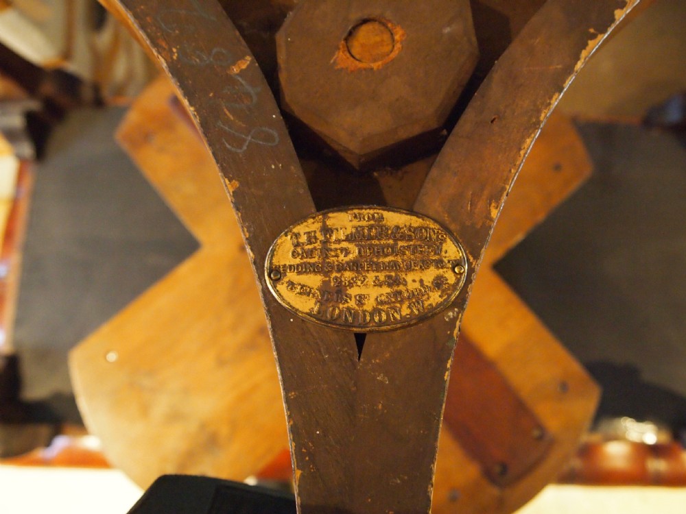 A circular Victorian burr walnut revolving library table featuring parcel gilt detailing, a turned pedestal base, and lower gallery shelves. View III