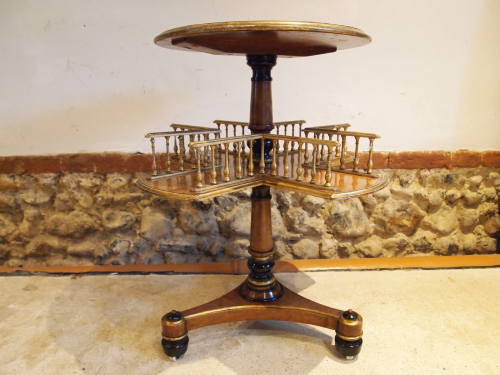 A circular Victorian burr walnut revolving library table featuring parcel gilt detailing, a turned pedestal base, and lower gallery shelves. View XIII