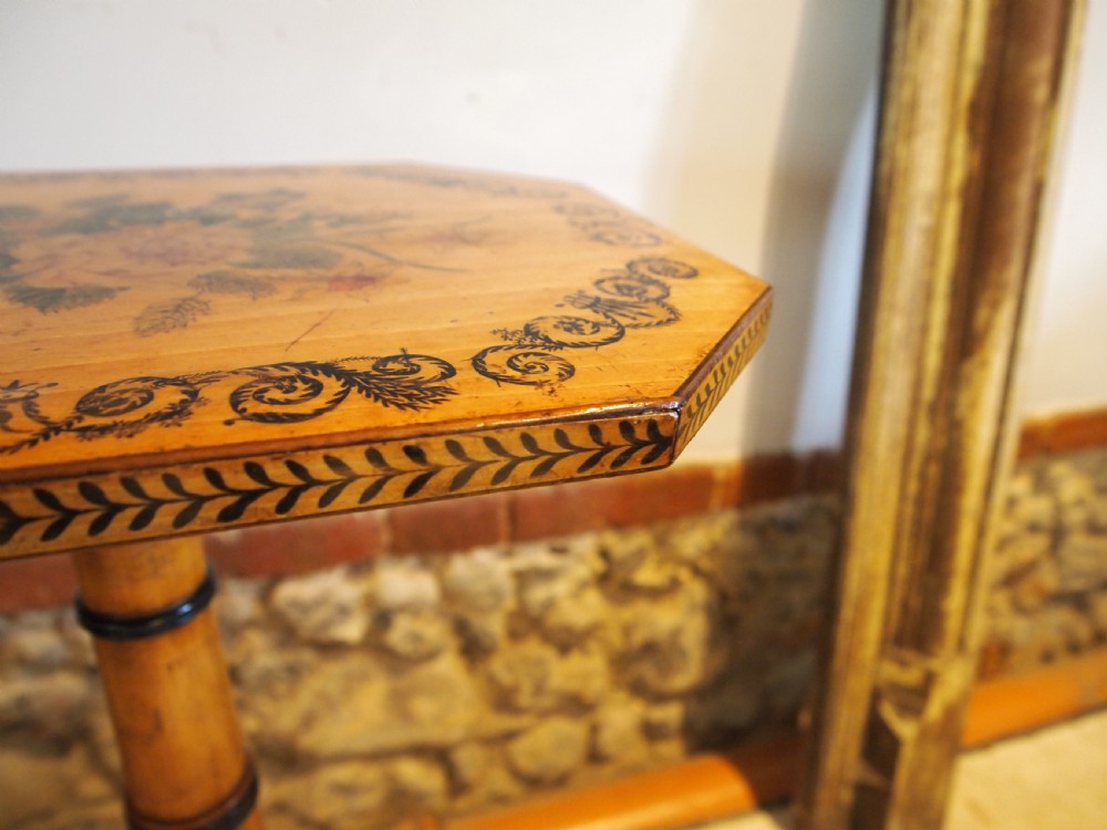 An octagonal Regency satinwood tilt-top table featuring hand-painted floral artwork on a slender turned column and tripod base. View III