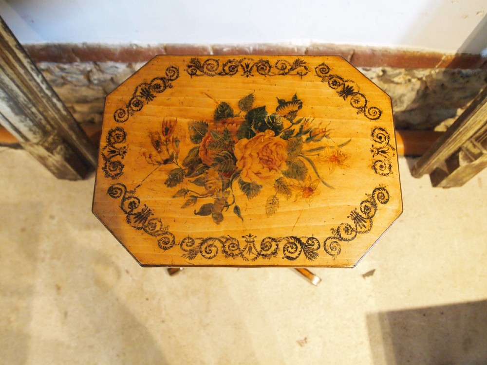 An octagonal Regency satinwood tilt-top table featuring hand-painted floral artwork on a slender turned column and tripod base. View V