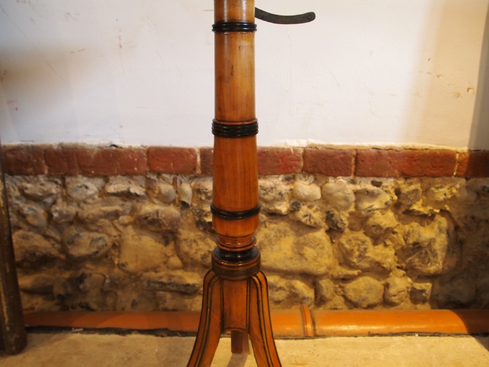 An octagonal Regency satinwood tilt-top table featuring hand-painted floral artwork on a slender turned column and tripod base. View VII