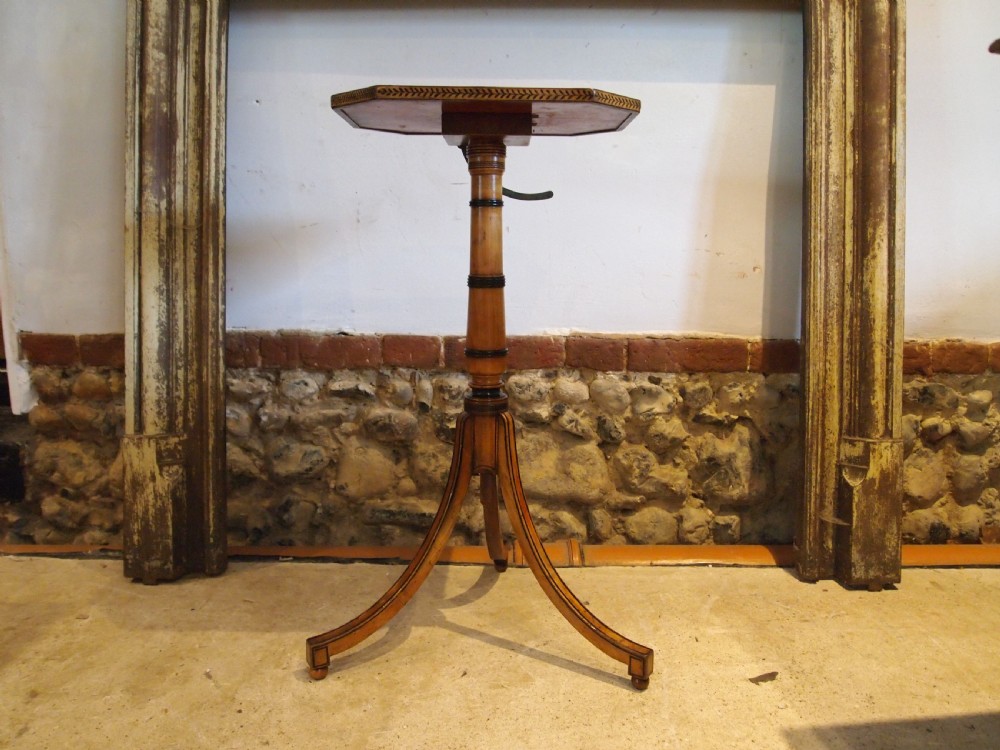 An octagonal Regency satinwood tilt-top table featuring hand-painted floral artwork on a slender turned column and tripod base. View VIII