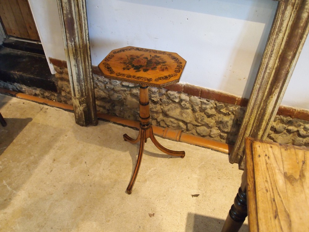 An octagonal Regency satinwood tilt-top table featuring hand-painted floral artwork on a slender turned column and tripod base. View XI