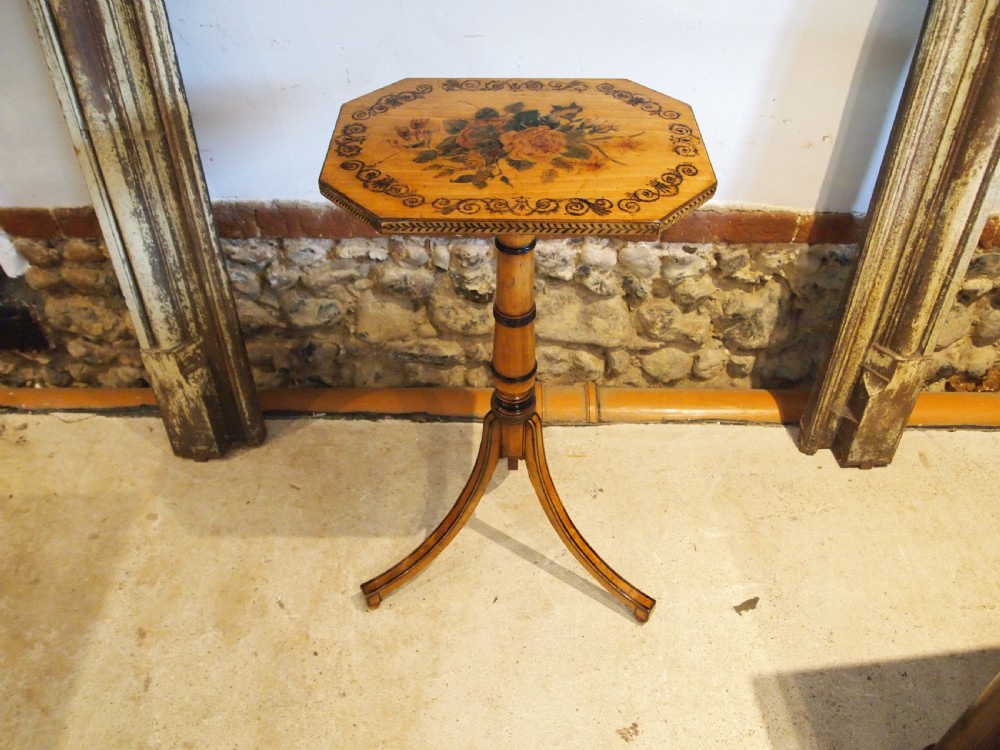 An octagonal Regency satinwood tilt-top table featuring hand-painted floral artwork on a slender turned column and tripod base. View XII