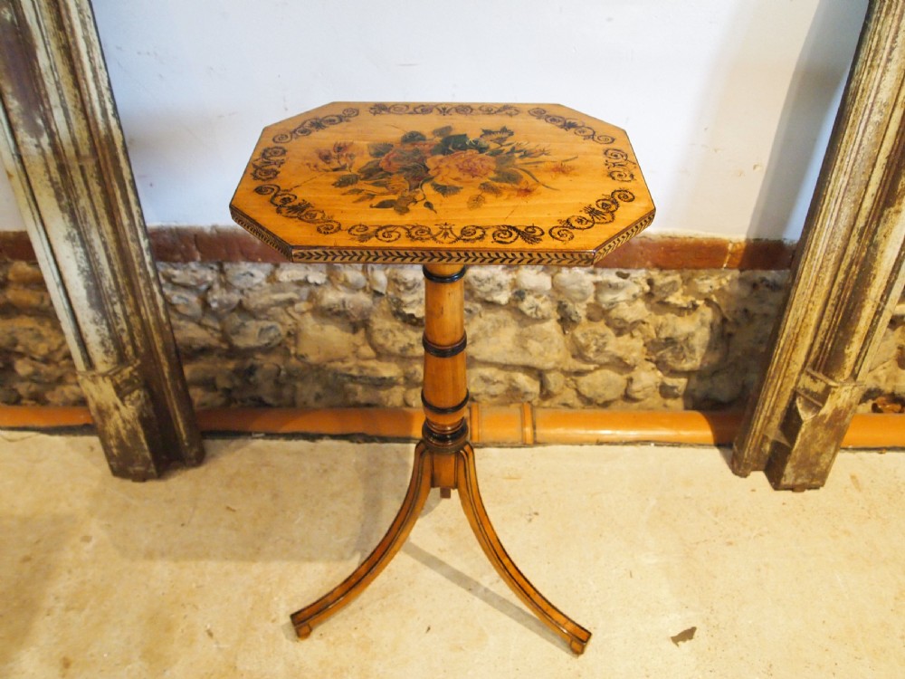 An octagonal Regency satinwood tilt-top table featuring hand-painted floral artwork on a slender turned column and tripod base. View XIII