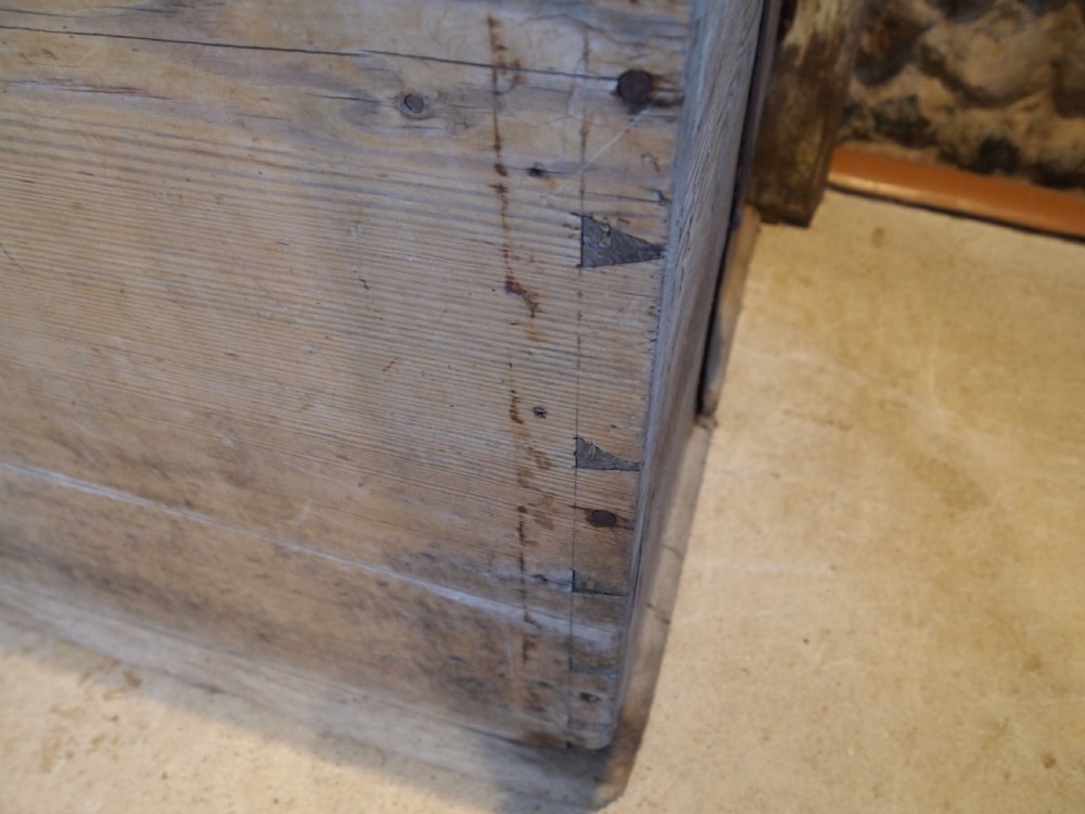 An eighteenth-century Scandinavian pine marriage chest featuring a domed lid, wrought iron corner brackets, and a central decorative iron escutcheon plate. View II